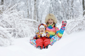 Little cheerful girl on a winter walk in the snow