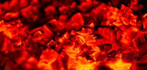 Burning without flame against a dark background