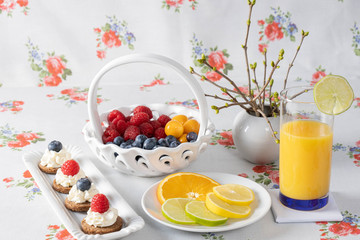 Various berries in a basket and cakes.