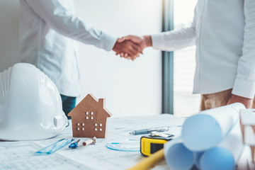 Team Engineer colleagues shaking hands and meeting for architectural project on workplace