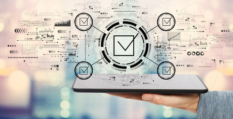 Checklist concept with man holding a tablet computer