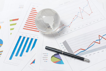 Business presentation with glboe and chart on the desk