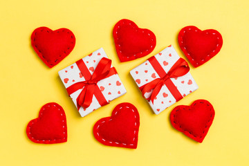 Top view of colorful valentine background made of gift boxes and red textile hearts. Valentine's Day concept