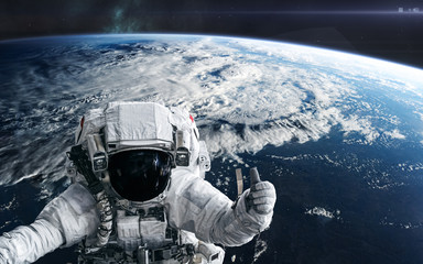 Astronauts in orbit of planet Earth. Solar system. Science fiction. Elements of this image...