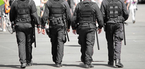 policemen in riot gear during a demonstration