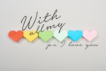 Top view of paper hearts on grey background with all my and ps i love you illustration