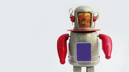 Vintage tin robot toy isolated on a white background....