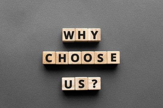 why choose us? - words from wooden blocks with letters, top view gray background