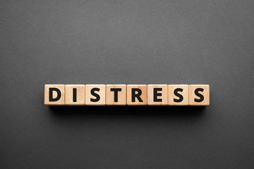 Distress - words from wooden blocks with letters, great mental or physical suffering distress...
