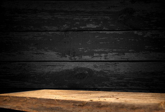 Empty Wooden Table On A Background Of Dark Blurred Wall, Empty Space For Product Above.