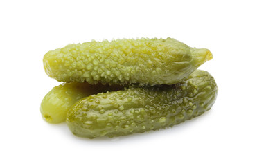 three marinated pickled cucumbers isolated on white