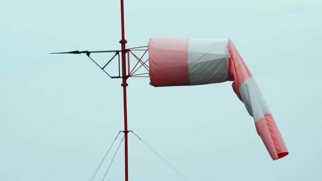 Close-up shot of Windsock at airport. Blue sky in the background