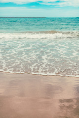 Beach sea water flow with blue sky. Seascape wallpaper.