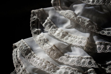 Detail of vintage jabot. White jabot. Jabot.