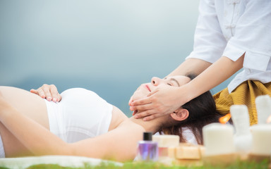 Pregnant women are massaging with hot compress methods. The masseuse will massage the pregnant women to feel relaxed.