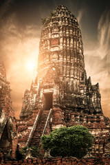 Asian religious architecture. Ancient Buddhist pagoda ruins at Chai Watthanaram temple under sunset sky. Ayutthaya, Thailand travel landscape and destinations