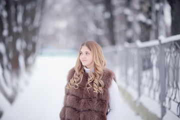 walk in a winter park christmas girl / beautiful model posing in the winter season walk city park