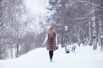 Fototapeta na wymiar winter blonde / young adult model, blonde with long beautiful hair posing in the winter season