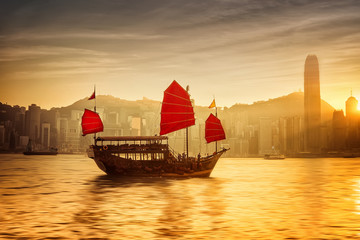 Sunset at Hong Kong with traditional cruise sailboat