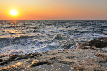 Beautiful golden sunset over Black sea rocky coastline in Crimea