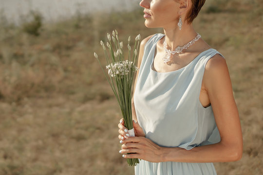 Blue vintage wedding beauty woman with simple elegant wedding bouquet . Elegant bride portrait 
