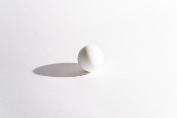 White egg on a white background in the center. Modern easter card. Design, visual art, minimalism