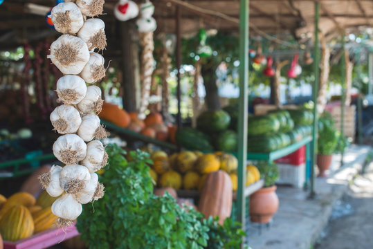 Greece, garlic braid at a vegetable stand on market