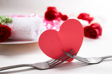 A romantic dinner for two in a restaurant on Valentine's Day.