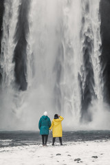 young beautiful couple travelers girl in yellow clothes a man in green clothes stands near a...