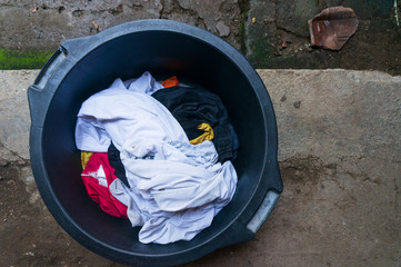 Dirty clothes in the washing bath. By washing clothes regularly, health is better