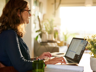 Mature female entrepreneur working at a table from home