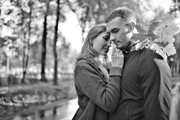 autumn landscape with people in the park / gerfrend and boyfriend hug in autumn park, fall view person
