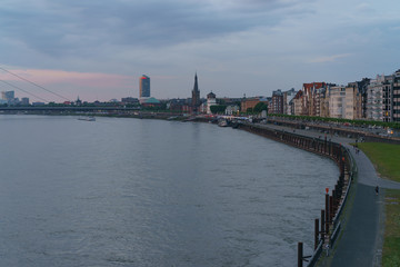Fototapeta premium Dusseldorf embankment in Altstadt at cloudy blue sunset. 