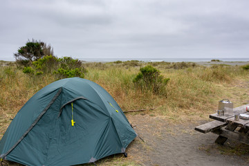 Tourist camp with a tent on the shore of the Pacific Ocean, California United States