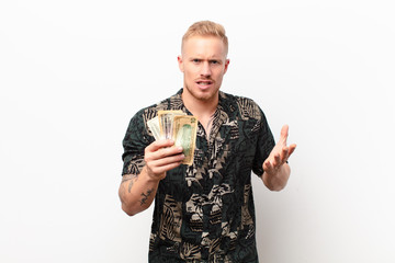 young blonde man looking angry, annoyed and frustrated screaming wtf or what‚Äôs wrong with you...