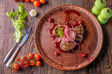 Veal medallions with cherry sauce, served with pickled onions and radishes, a gourmet dish, Close up, Horizontal orientation