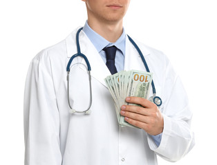 Doctor with bribe on white background, closeup. Corruption in medicine