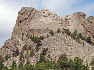 Iconic sculpted Presidential faces of George Washington, Thomas Jefferson, Theodore Roosevelt, and Abraham Lincoln  at the Mt. Rushmore National Memorial, Keystone, South Dakota - 317778068