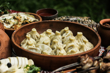 National Georgian cuisine. Khinkali on the pottery. Georgian food