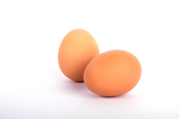 Isolated brown eggs in front of white background