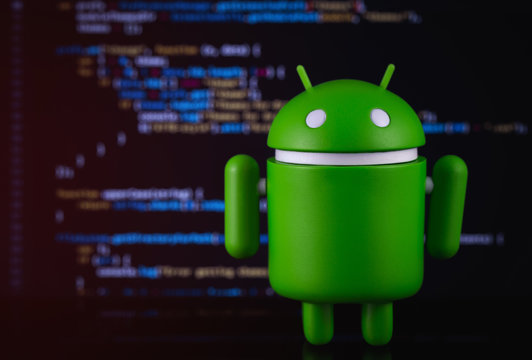 Google Android figure on blurred digital background. Google Android is the operating system for smartphones, tablet computers, e-books, and other devices. Moscow, Russia - March 18, 2019