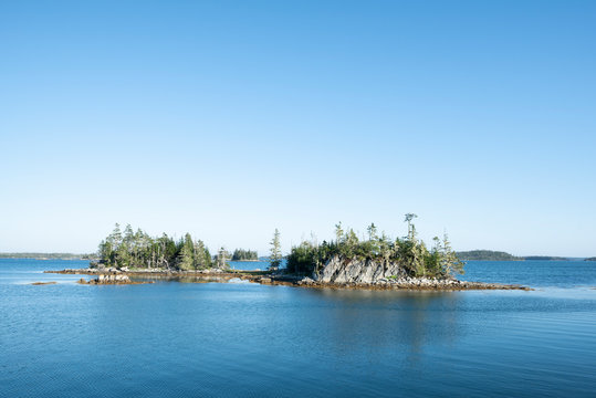 Canada, Nova Scotia, Mitchell Bay, Clear sky over small forested islands