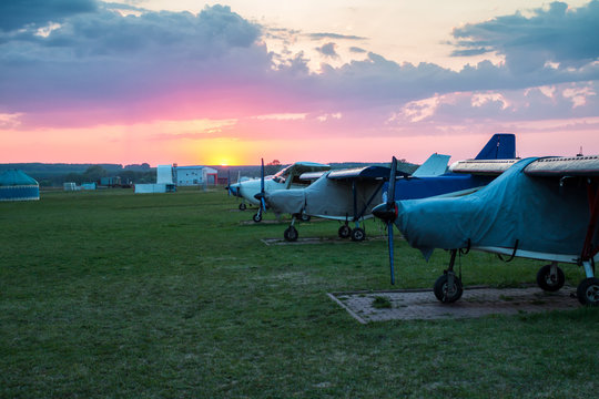 Small Private Airplanes Parked At The Airfield At Scenic Sunset