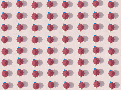 Indonesia, Bali, Aerial view of rows of red beach umbrellas