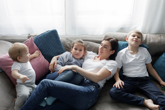 Family relaxing on couch in living room at home