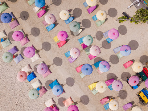 Indonesia, Bali, Nusa Dua, Aerial view of colorful umbrellas on resort beach