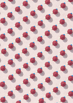 Indonesia, Bali, Aerial view of rows of red beach umbrellas