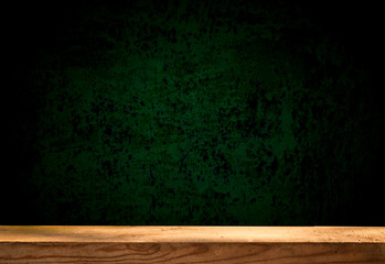 Empty wooden table on a dark concrete background, blurred brick wall, empty space for the product above.