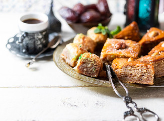 Ramadan kareem with arabic coffee and traditional arabic dessert baklava with honey and nuts. Arabian style. Ramadan breakfast concept.