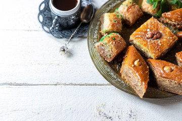 Ramadan kareem with arabic coffee and traditional arabic dessert baklava with honey and nuts. Arabian style. Ramadan breakfast concept.